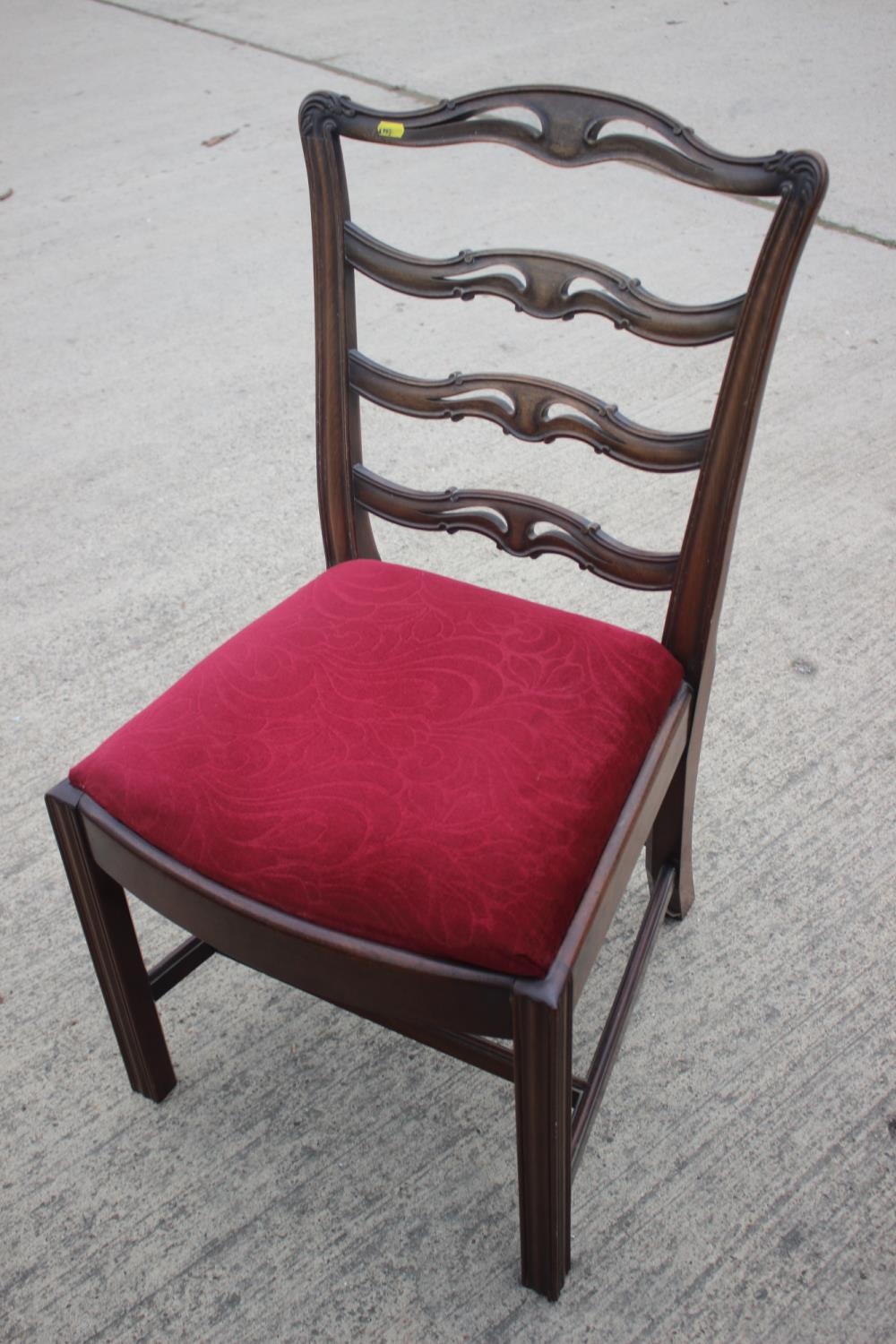 A Georgian carved mahogany ladder back dining chair of Chippendale design with drop-in seat, on