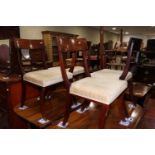 A matched set of four early 19th century mahogany bar back standard dining chairs with stuffed