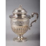 A white metal drinking cup with floral band inscribed, "The gift of his best friend Adam Ogilvy" and