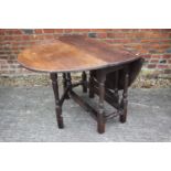 An antique oak oval top gate leg dining table, on turned and stretchered supports (new feet blocks),
