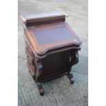 A carved hardwood Davenport desk, the interior fitted two drawers with eight further drawers to