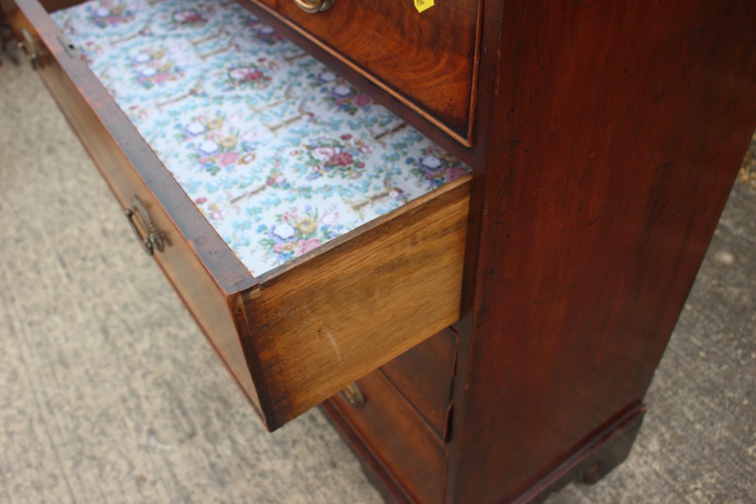 A 19th century figured mahogany chest of two short and three long graduated drawers with oval - Image 5 of 9