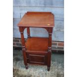 A mahogany bedside table, fitted cupboard, on turned supports, 16" wide x 14" deep x 31" high