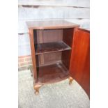 A mahogany bowfront cupboard enclosed shelf, on cabriole supports, 20" wide