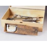 A Mitutoyo vernier gauge, two other gauges, a micrometer, a Brown & Sharpe micrometer,