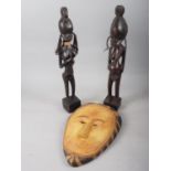 Two African fertility figures, 19" high, and a similar carved mask