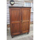 A 19th century rosewood side cupboard, interior fitted shelves enclosed two panelled doors, on