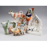 A Staffordshire spill vase with man on fence and woman with dog, 6" high, another spill vase, a