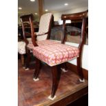 A pair of 19th century carved mahogany bar back side chairs with needlepoint seats, on sabre