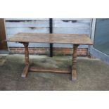 An oak refectory table, on twin turned and stretchered supports, 60" wide x 26 1/2" deep x 29 1/2"