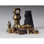 A brass 4lb dumbbell weight, three smaller dumbbell weights, a set of five metric weights, 10g-200g,