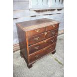 An 18th century oak chest of two short and three long graduated drawers with brass handles, on