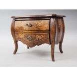 A miniature polished and grained as walnut inlaid Continental two-drawer commode with swag