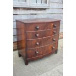 A mahogany bowfront chest of two short and three graduated long drawers with knob handles, on ogee