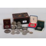 A quantity of coins, including commemorative crowns, in a lacquered box, and an animal skin effect