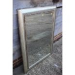 A silvered frame wall mirror with bevelled plate, 23" x 35", and a carved hardwood framed wall