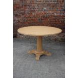 A Dan Field birch circular dining table, on turned column and quadruple splay supports, 42" dia