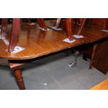 A 19th century mahogany extending dining table with one extra leaf, on faux bamboo turned and