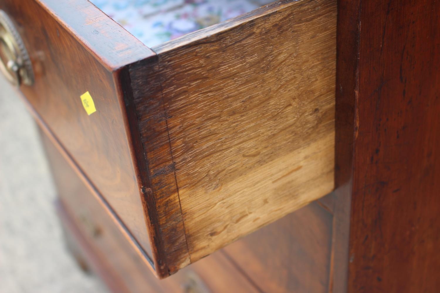 A 19th century figured mahogany chest of two short and three long graduated drawers with oval - Image 4 of 9