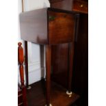 A 19th century mahogany bedside cupboard with drop front and flap, on square taper supports, 15 1/2"