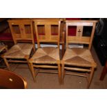 A set of seven chapel chairs with rush envelope seats, on turned and stretchered supports