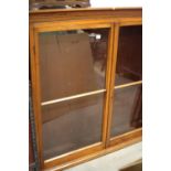 A late 19th century walnut bookcase, fitted three shelves enclosed glazed doors, on block base, 57
