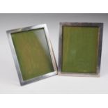 A pair of engine turned silver photograph frames, 9 1/4" overall (one easel damaged)