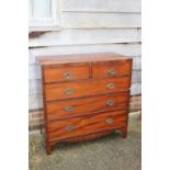 A Georgian mahogany chest of two short and three long graduated drawers with oval brass handles,