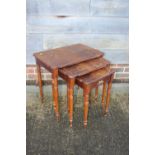 A nest of three figured mahogany and line inlaid occasional tables, largest 22" wide x 15" deep x