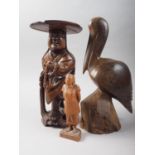 A Chinese carved hardwood figure of a man with prayer beads, 11 1/2" high, a Burmese carved hardwood