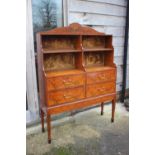 A Sheraton Revival painted satinwood and kingwood banded waterfall bookcase, fitted four drawers, on