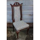 An Edwardian walnut side chair with padded back, on cabriole supports, and a carved oak side chair