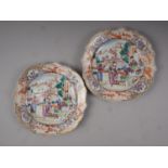 A pair of Chinese export shaped dishes with polychrome figure decoration, 9" dia (chips and frits to