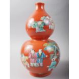 A 20th century Chinese porcelain double gourd vase, decorated children playing on a coral powder