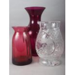 A purple glass baluster vase, 13 1/4" high, a cranberry glass vase, 8 3/4" high, and a clear cut