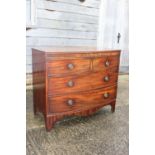 A Georgian mahogany bowfront chest of two short and two long drawers with ring handles, on bracket