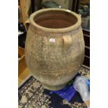 A Greek terracotta jar with three handles, 33 1/2" high