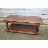 An oak two-tier coffee table, on turned supports, 47" long x 23 1/2" wide x 18" high, and a dressing