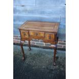An 18th century design walnut and banded lowboy, fitted one long drawer and two short drawers, on