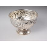 An embossed silver rosebowl with scroll decoration and two cartouches, 16.3oz troy approx (dented to