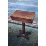 A 19th century figured walnut flap top work table, on octagonal tapered column and quadruple