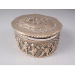 A silver embossed trinket box with putti decoration, 5.8oz troy approx