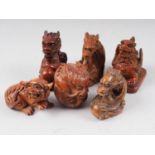 Four carved hardwood dragon netsuke and two other mythical beast netsuke