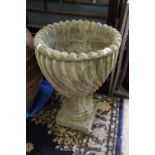 A cast stone spiral fluted urn, on square base, 26" high