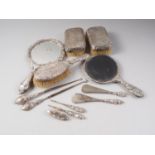 Two silver backed toilet mirrors, three silver backed brushes, two silver mounted button hooks, etc