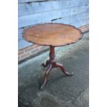 A late Georgian carved mahogany pie crust tilt top occasional table with birdcage, on turned