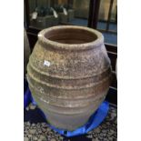 A Greek ribbed terracotta jar, 27" high