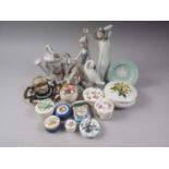 Three pieces of Lladro, including a woman feeding a bird, 6 3/4" high, an assortment of pill boxes