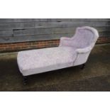A late Victorian day bed, upholstered in a cut velvet, on turned and castored supports, 60" long