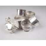 A pair of silver napkin rings, three other napkin rings, 2.9oz troy approx, and a paperweight,